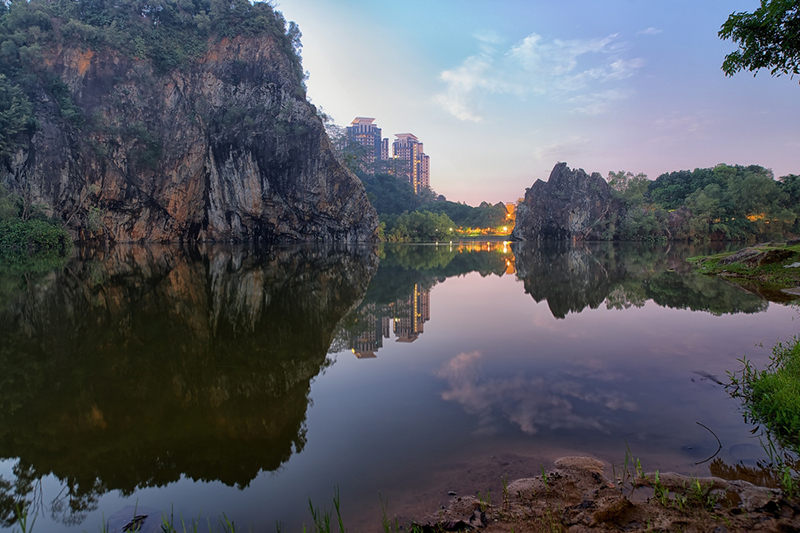 A panoramic view of granite rocks rising from the lake at Bukit Batok Park, also known as Little Guilin